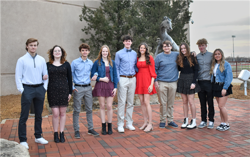 Homecoming candidates standing in front of the Bronco statue in the Bronco Plaza.