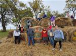Life Skills students and teachers pose in front of haybales for a photo.