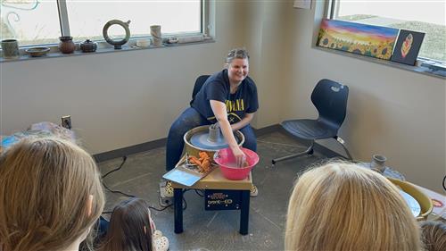 Miss Alisyn Lucas demonstrates throwing pottery.