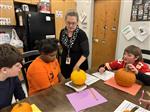 Students measure and weigh pumpkins.