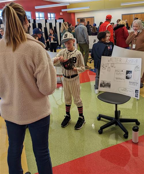 Student giving speech about Walter Johnson during the 4th Grade Famous Kansan Wax Museum