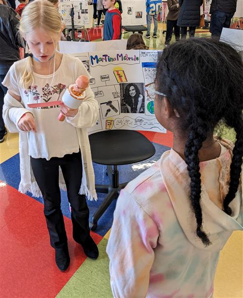 Student giving speech about Martina McBride during the 4th Grade Famous Kansan Wax Museum