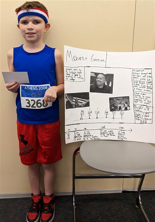 Student posing as Maurice Greene during the 4th Grade Famous Kansan Wax Museum