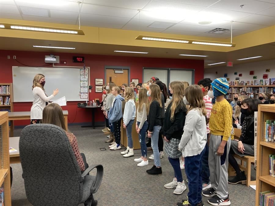  5th grade students signing to the board