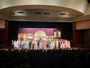 Students line the stage at end of performance of Music Man.